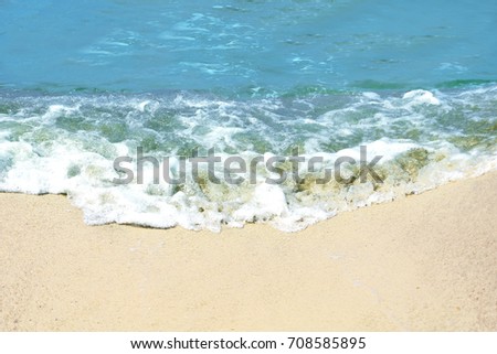 Soft wave of blue ocean on sandy beach. Background.                                                              