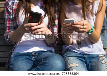 Happy teenage girls hawing fun spend time together in the city park