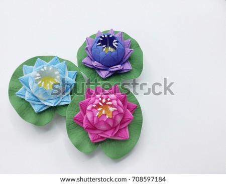Pink, purple and blue artificial lotus on white background