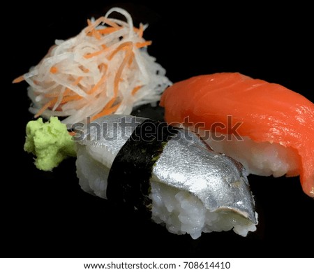 Sashimi Sushi set with salmon, tuna, wasabi and shredded radish are on the black background. Selective focus. Isolated picture.