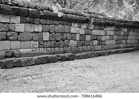 Walls made with red sandstone of temple in Eastern of Thailand. Black and white picture.