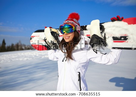 Happy young snowboard girl on the snow sunny day