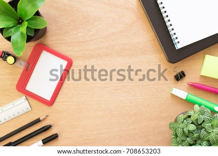 Book, paperclip, pencil, ruler, Highlighting pen, employee card, post it and tree pot on rustic brown wooden desk. Lifestyle workspace, top view.