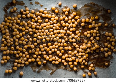 Many chickpeas with soy sauce on parchment close-up