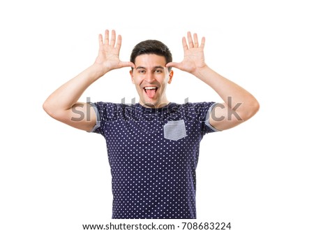 Cheerful young men fooling around with horns hand gesture against his temples isolated on white