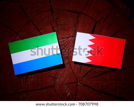 Sierra Leone flag with Bahraini flag on a tree stump isolated