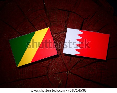 Republic of the Congo flag with Bahraini flag on a tree stump isolated