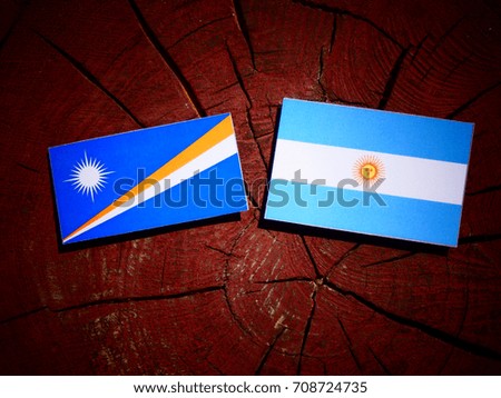 Marshall Islands flag with Argentinian flag on a tree stump isolated