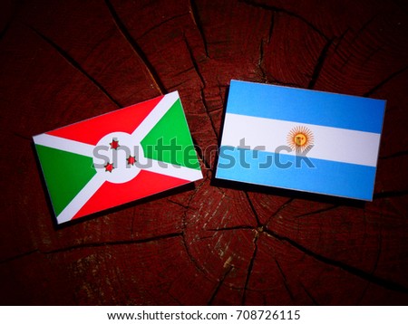 Burundi flag with Argentinian flag on a tree stump isolated