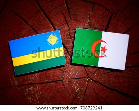 Rwanda flag with Algerian flag on a tree stump isolated