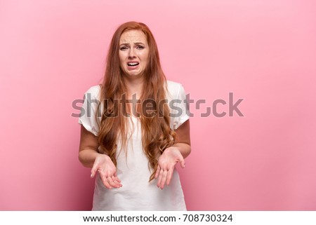 The beautiful woman is offended on pink studio