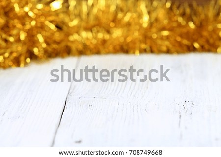 Christmas golden chain  on white wooden table Christmas chain  on board, good for background 