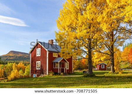 Cottage with garden with autumn colors in a mountain landscape Royalty-Free Stock Photo #708771505