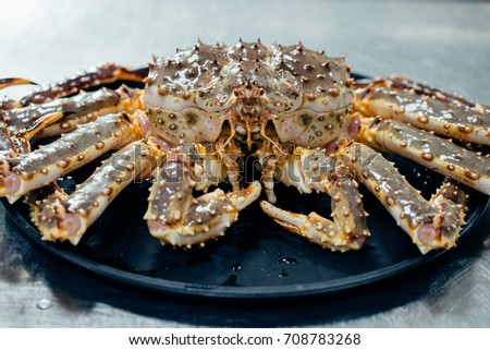 Taraba sea crabs or alaska king crab on black plate
