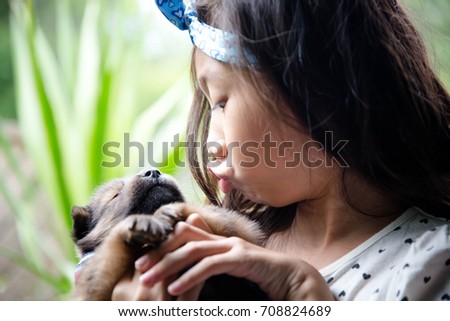 Asian little girl with cute puppy,Friend and love