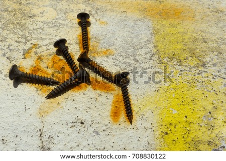 Old screw is rust on the floor background,Used for various tasks design