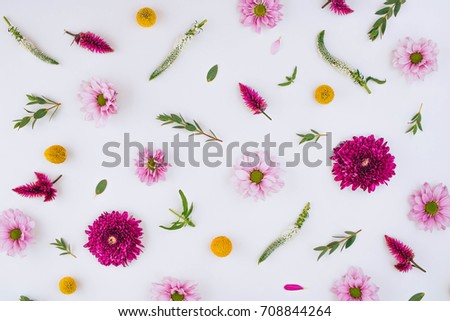 A bright creative pattern of fresh flowers and leaves. Natural background. Flowers pattern. Flat lay.