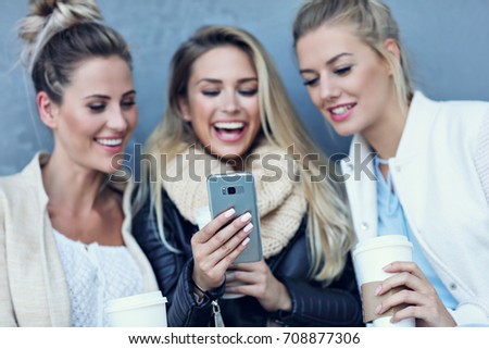 Happy group of friends taking selfie outside in autumn season