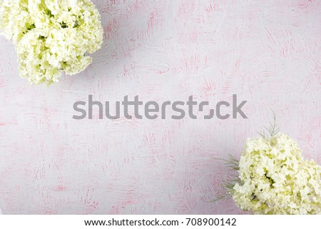 Workspace with computer, bouquet Hydrangeas, clipboard. Women's fashion accessories isolated on pink background. Flat lay. Top view office desk