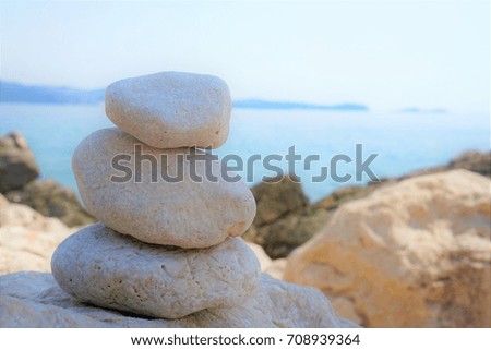 Pyramid of sea stones lying on the sea coast