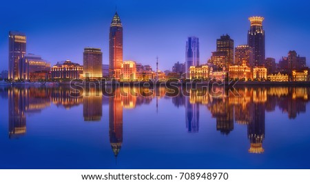 Beautiful chinese cityscape of Shanghai's skyline with the city lights and tower on the Huangpu River bay, Shanghai, China.