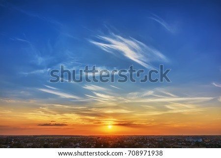 Sky and clouds at sunset over evening city.