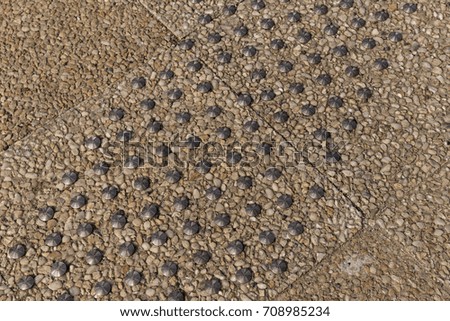 Metal pins on a cement pavement