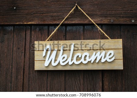 Welcome sign on wooden wall