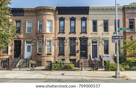 A row of brick apartment buildings on the corner of St. Johns and St. Francis Place in the Crown Heights Neighborhood of Brooklyn, New York