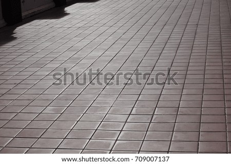Texture of the tile on the floor.