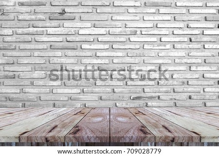 Empty perspective wood plank table top with white brick wall texture, background is for backdrop design