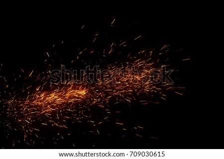 Fire sparks came from campfire isolated on black background for overlay design 