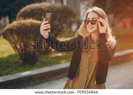 pretty girl in the summer city with smartphone
