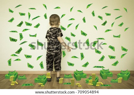 Money concept. Online earnings. Even a child can cope. The child at the wall collects money. Photo for your design
