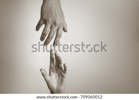 Hand reaching out to help another. People helping each other. 