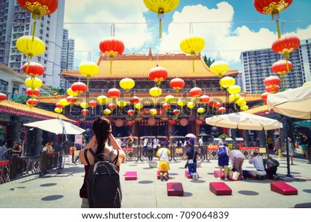 Female traveler photographing temples at Wong Tai Sin Temple Hong Kong landmark
