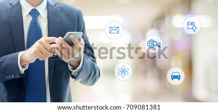 Businessman using smart phone with internet of things icon on blurred background, business and technology concept