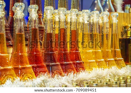Presents wine in a souvenir bottle in the shape of the Eiffel Tower - symbol of France at the Christmas market in Paris