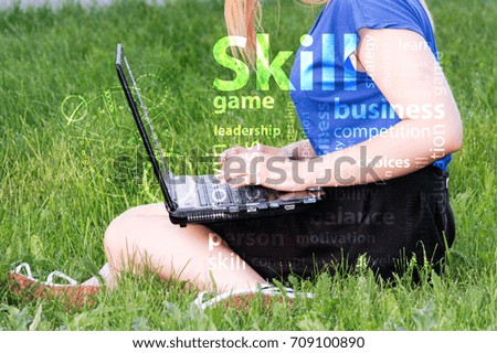 skill concept.photo for your design. girl with laptop on the grass