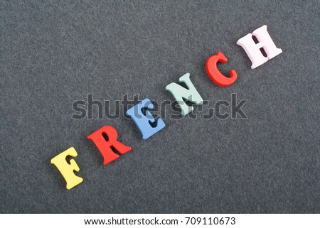 FRENCH word on black board background composed from colorful abc alphabet block wooden letters, copy space for ad text. Learning english concept