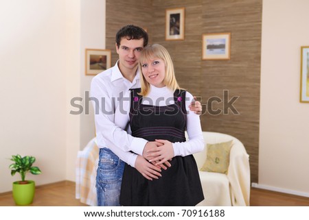 young pregnant wife and her husband at home together