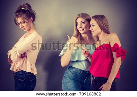 Woman being bullied by her two female friends. Friendship rivaly and envy problems. Royalty-Free Stock Photo #709168882