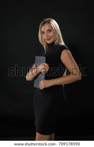 Young happy woman portrait of a confident businesswoman showing by hands on a black background. Ideal for banners, registration forms, presentation, landings, presenting concept