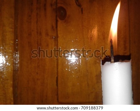 Candle in front of wooden door.