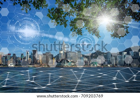 Communication network with digital virtual screen of Hong Kong Cityscape river side in the afternoon with smooth cloud at Victoria harbor, Technology Smart City with Internet of Things concept