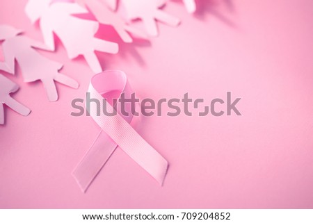 Sweet pink ribbon shape with girl paper doll on pink background  for Breast Cancer Awareness symbol to promote  in october month campaign