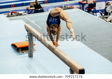 woman gymnast acrobatic skill in balance beam gymnastics