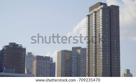 Exterior establishing photo of typical urban city apartment building during day time. New York City style construction