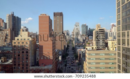 Generic aerial overhead view of urban city landscape down straight avenue road between tall buildings