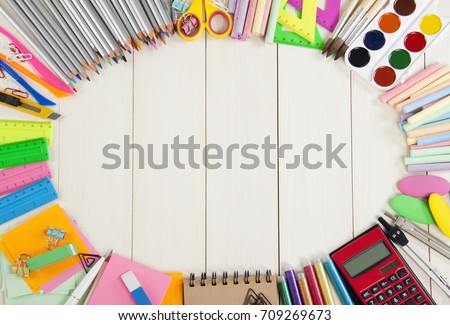 School supplies frame on a wooden background